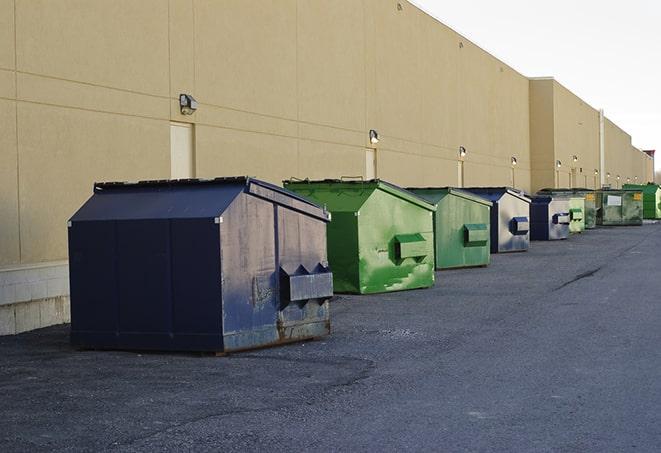 a group of construction workers taking a break near a dumpster in George West TX